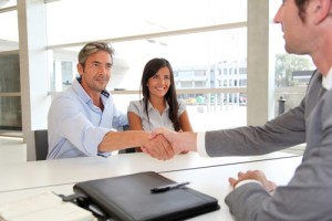 Couple reviewing loan guidelines and signing contract